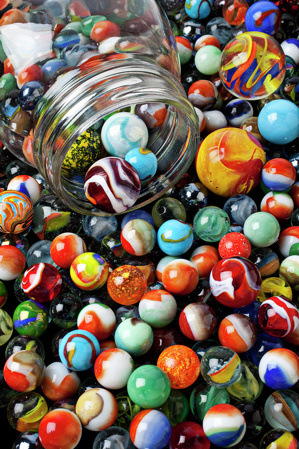 Glass jar and marbles Photograph by Garry Gay