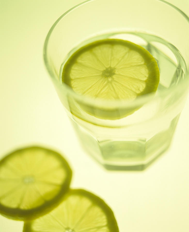 Cool Photograph - Glass Of Water With Sliced Lemon by Lawrence Lawry