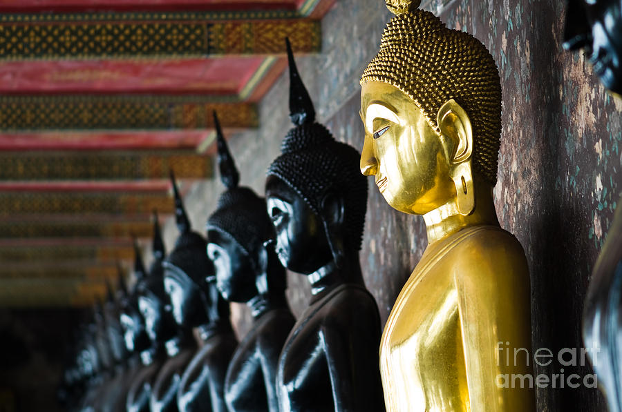 Buddha Photograph - Golden Buddha between black Buddhas by Sattapapan Tratong