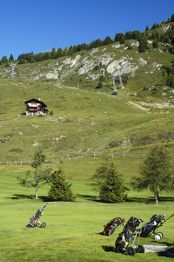 Golf bags on the green - Gold course Riederalp Switzerland Photograph by Matthias Hauser