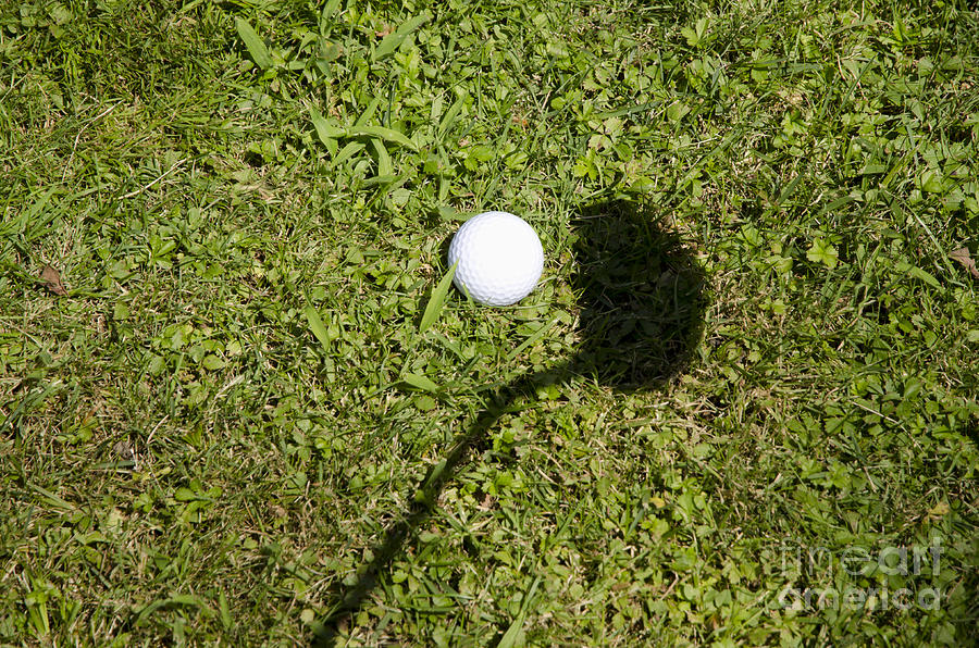 Golf ball and shadow Photograph by Mats Silvan