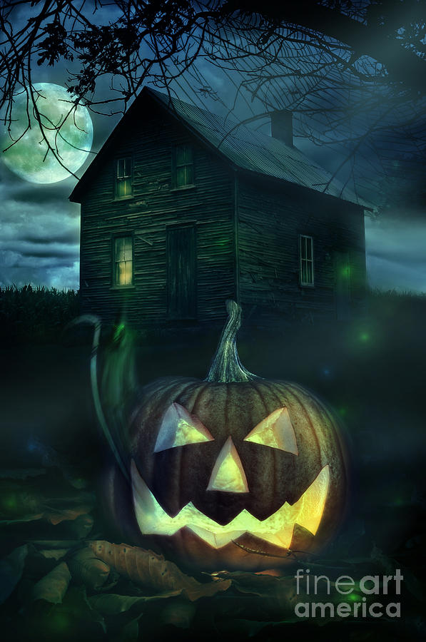 Halloween pumpkin in front of a Spooky house Photograph by Sandra Cunningham