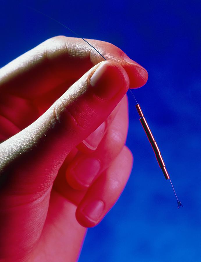 Iud Photograph - Hand Holds A Gynefix Intrauterine Contraceptive by Damien Lovegrove