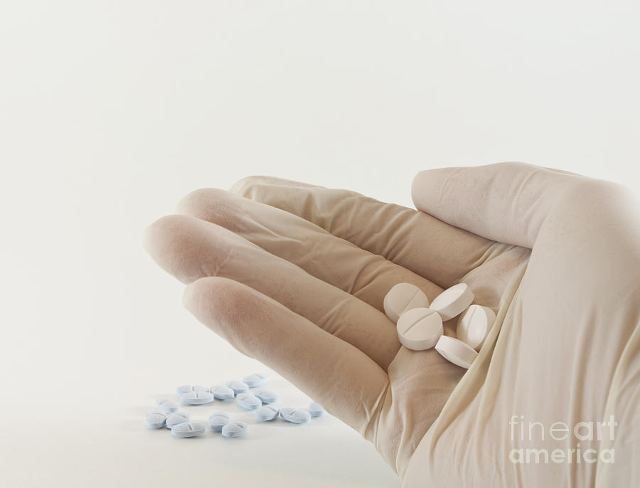 Glove Photograph - Hand with pills by Blink Images