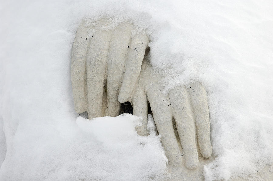 Hands of a statue covered with snow Photograph by Matthias Hauser