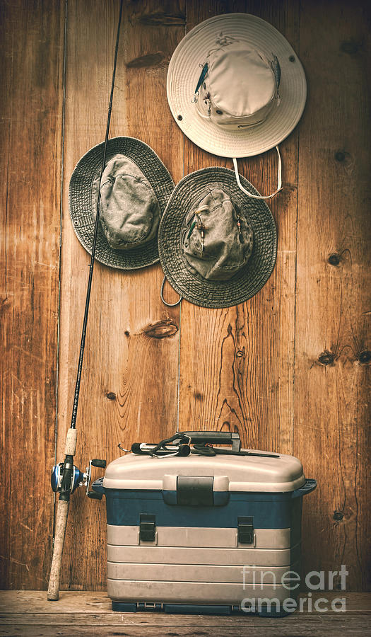 Hats hanging on wall with fishing equipment Photograph by Sandra Cunningham