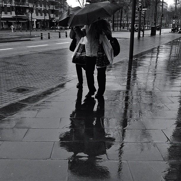 Blackandwhite Photograph - Hidden Under Their Umbrellas by Andres De Leon