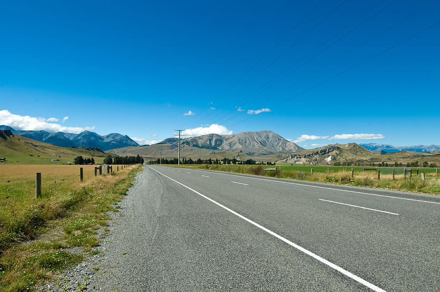 Highway towards panoramic mountain Photograph by U Schade