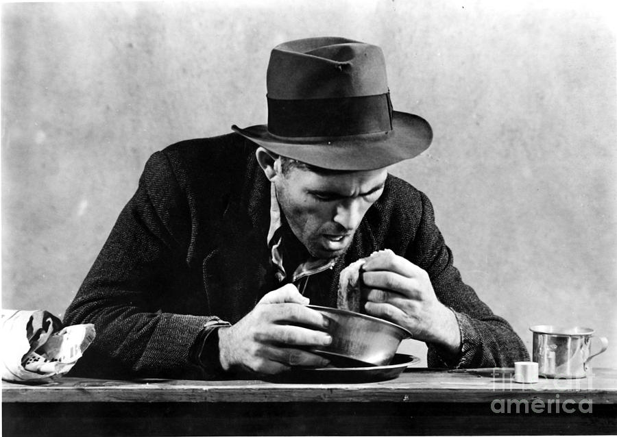 Homeless Man Eating In A Soup Kitchen Photograph by Photo Researchers