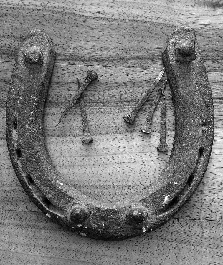 Horseshoe and nails Photograph by Jim Sauchyn