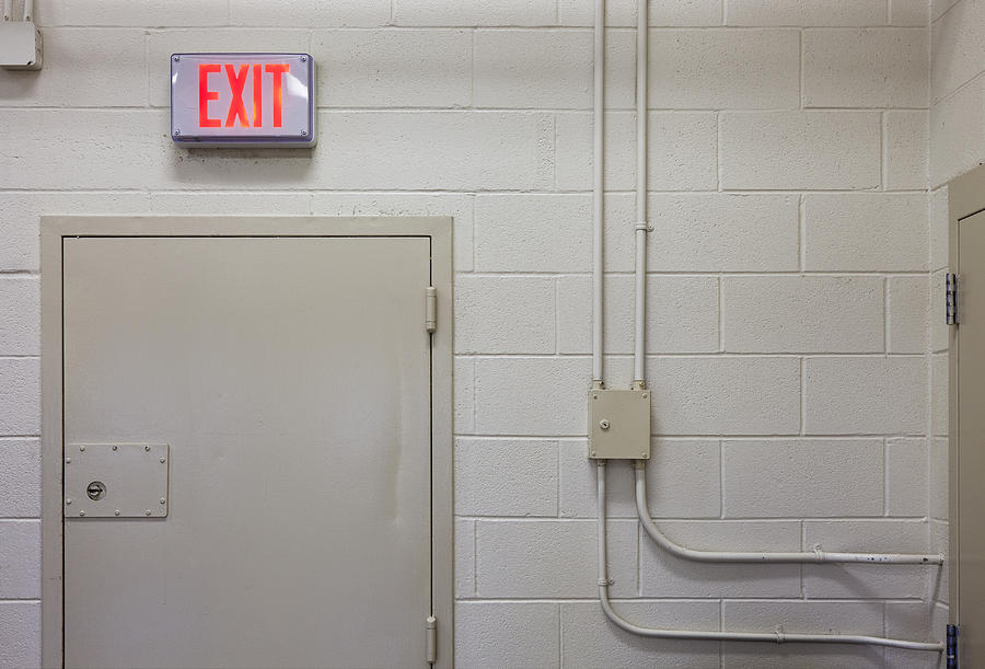 Interior Of A Prison Unit. Exit Sign Photograph by Roberto Westbrook ...