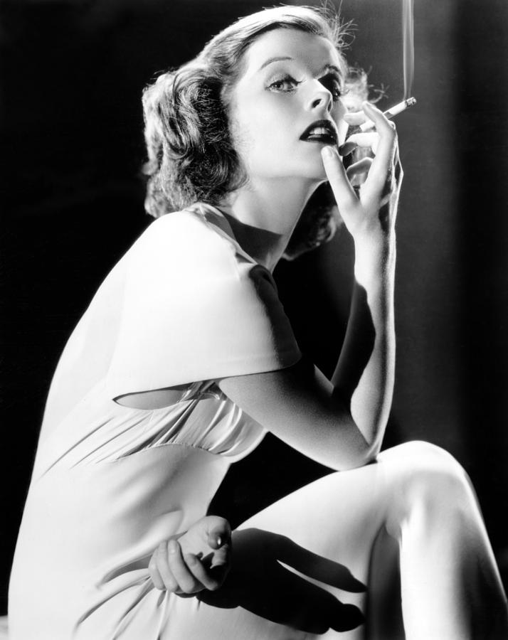 Portrait Photograph - Katharine Hepburn Smoking, 1930s by Everett
