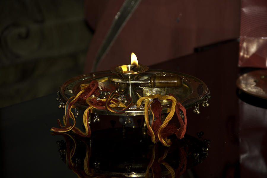 Lamp on a metal plate as part of a Hindu ritual Photograph by Ashish Agarwal