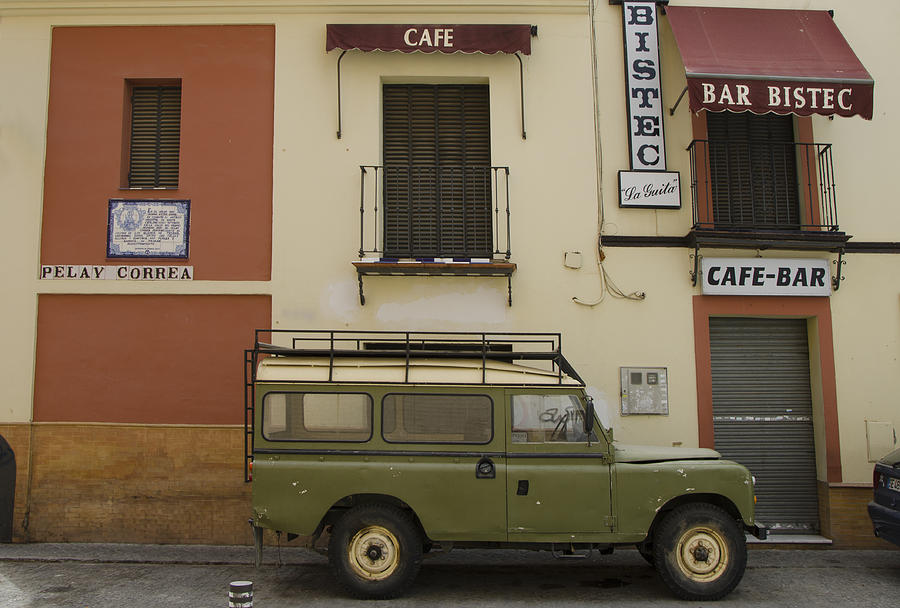 Landrover parked in front of bar Photograph by Perry Van Munster