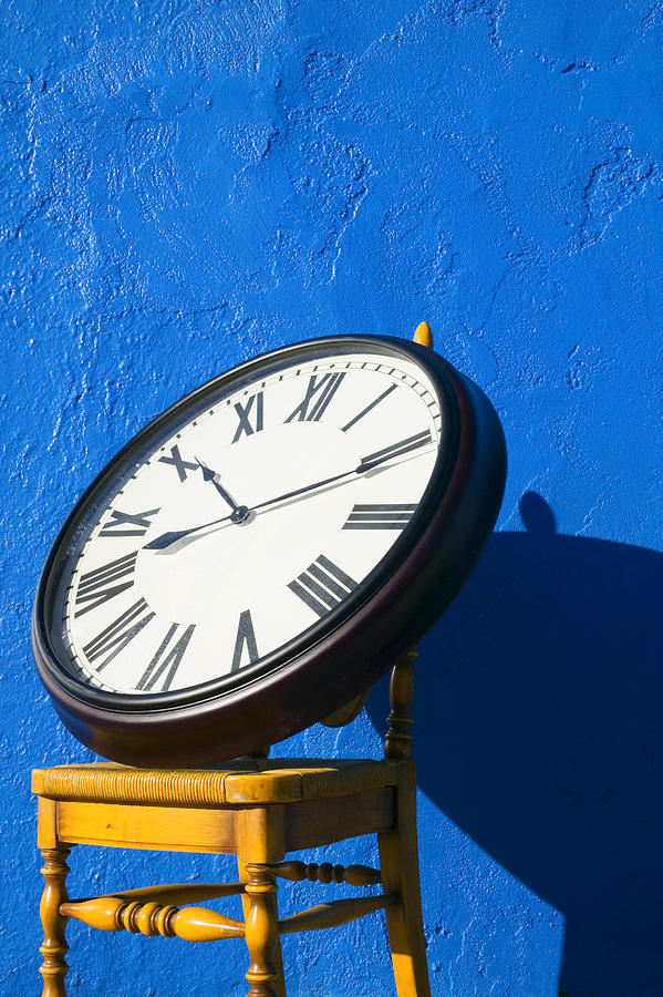 Still Life Photograph - Large clock on yellow chair by Garry Gay