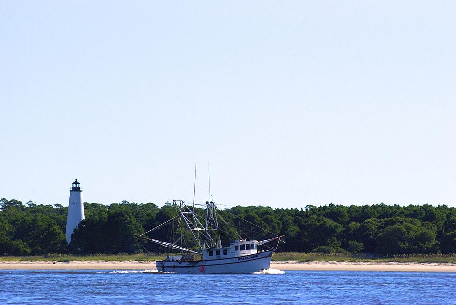 Lighthouse and Shrimp Boat Photograph by Ralph Jones
