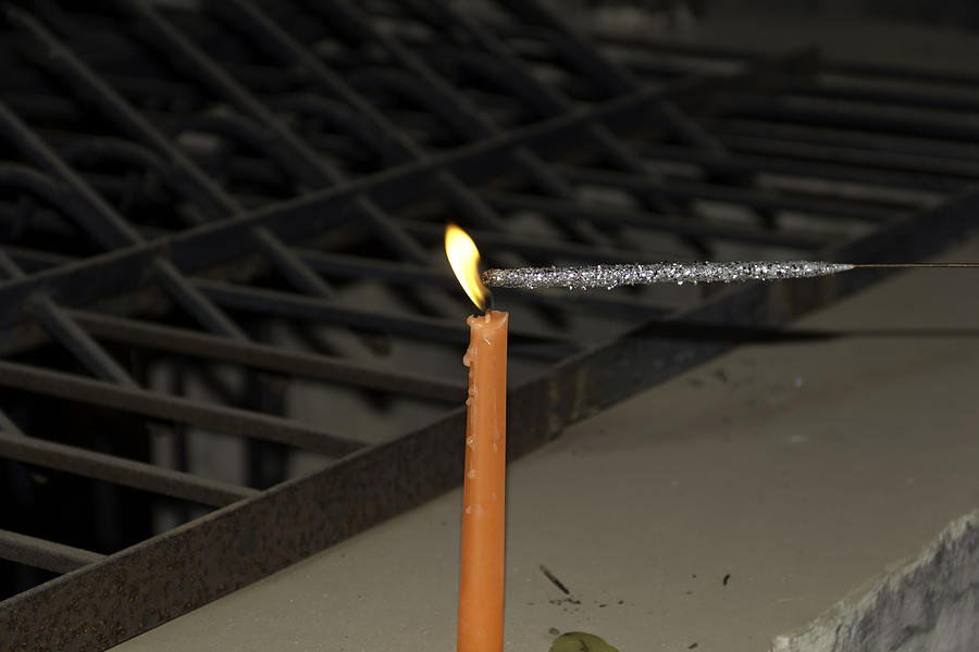 Lighting a sparkler with an orange candle Photograph by Ashish Agarwal