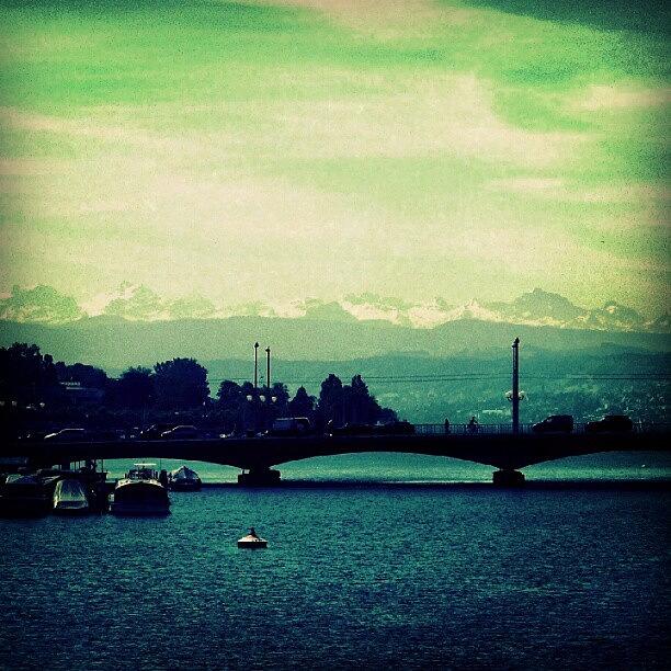 Zurich Photograph - Limmat River With Swiss Alps at the background by Sigit Pamungkas