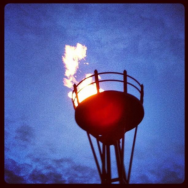 Sunset Photograph - Lit Torch For Illuminations At Epcot by Arnab Mukherjee