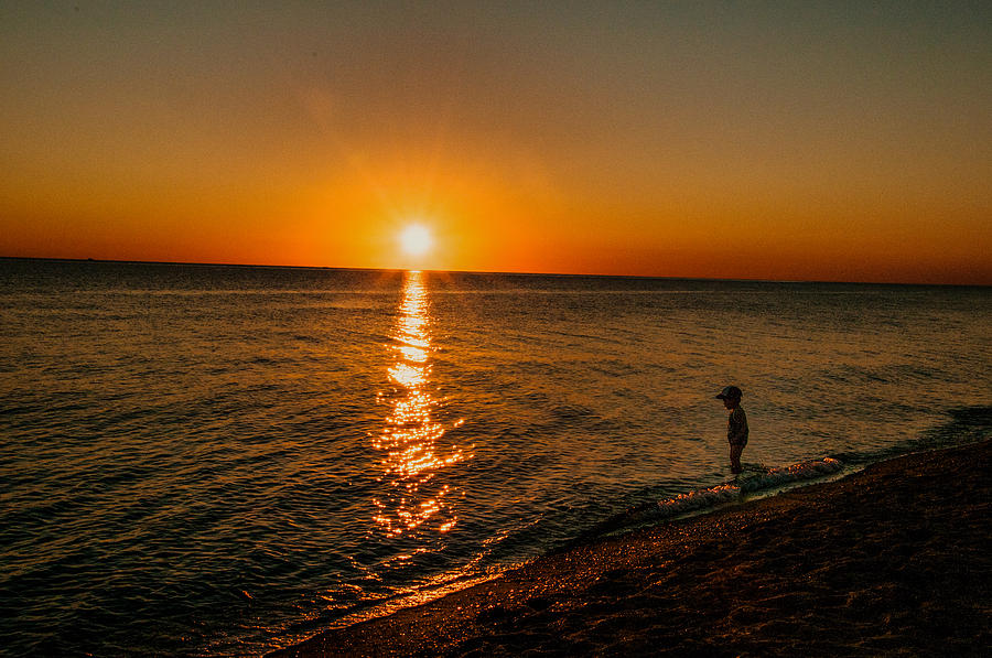 Little Boy Wading At Sunset Photograph by Linda Pulvermacher - Pixels