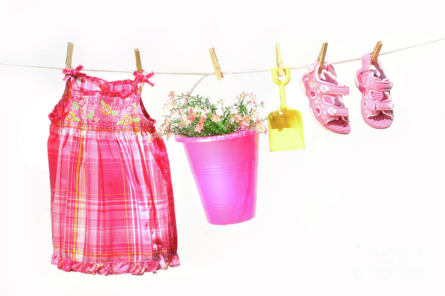 Little girl clothes and toys on a clothesline Photograph by Sandra Cunningham