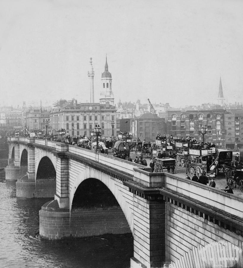 London Bridge showing carriages - coaches and pedestrian traffic - c 1900 Photograph by International  Images