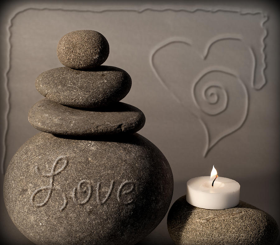 love - A simple pebble column with the light of love beside it Photograph by Pedro Cardona Llambias