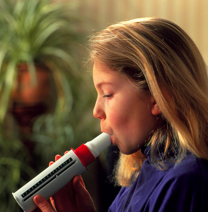 Lung Function Girl Breathes Into Peak Flow Meter Photograph by Damien