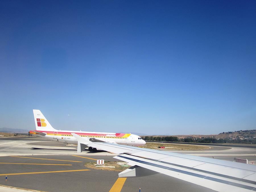 Madrid Airport Runway Airplane Waiting in Line to Take Off in Spain Photograph by John Shiron