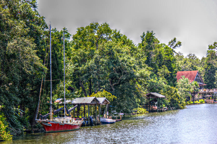 Magnolia River with a Red Sailboat Photograph by Lynn Jordan