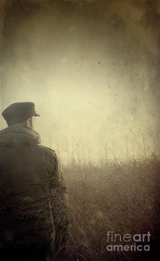 Man alone in Autumn field Photograph by Sandra Cunningham