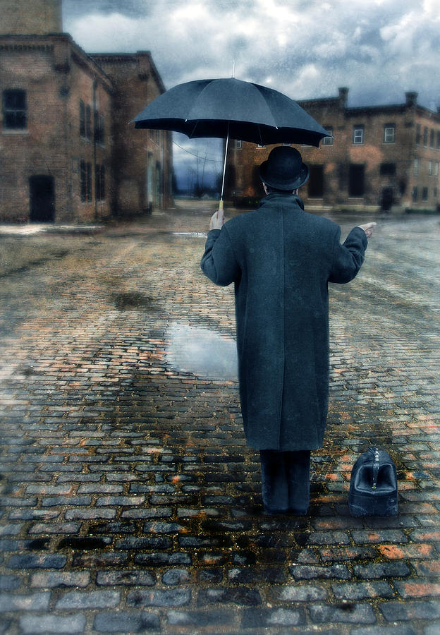 Man in Vintage Clothing with Umbrella on Rainy Brick Street Photograph by Jill Battaglia