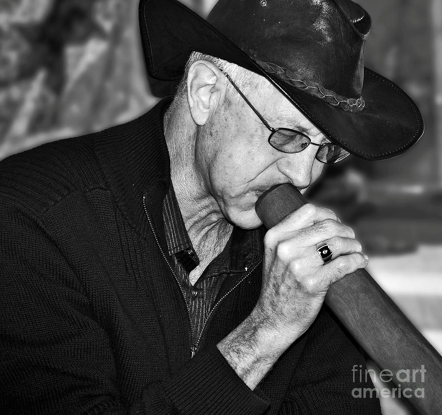 Black And White Photograph - Man Playing the Didgeridoo by Kaye Menner