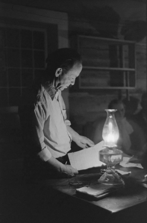 Man Reading By The Light Of A Kerosene Photograph by Everett