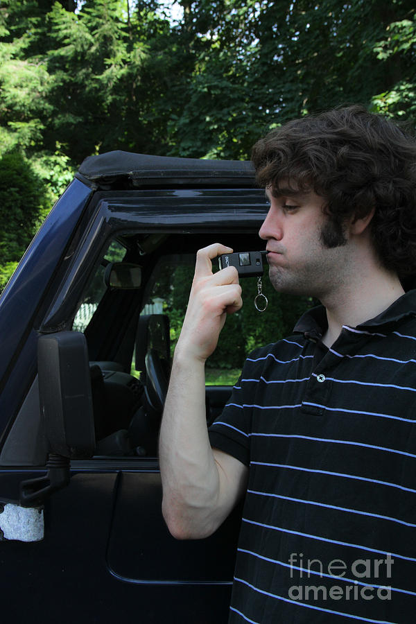 Man Using A Breathalyzer Photograph by Photo Researchers, Inc.