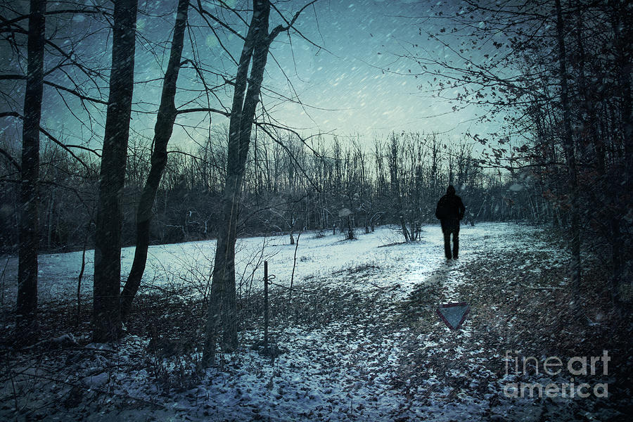 Man walking in snow at winter twilight Photograph by Sandra Cunningham