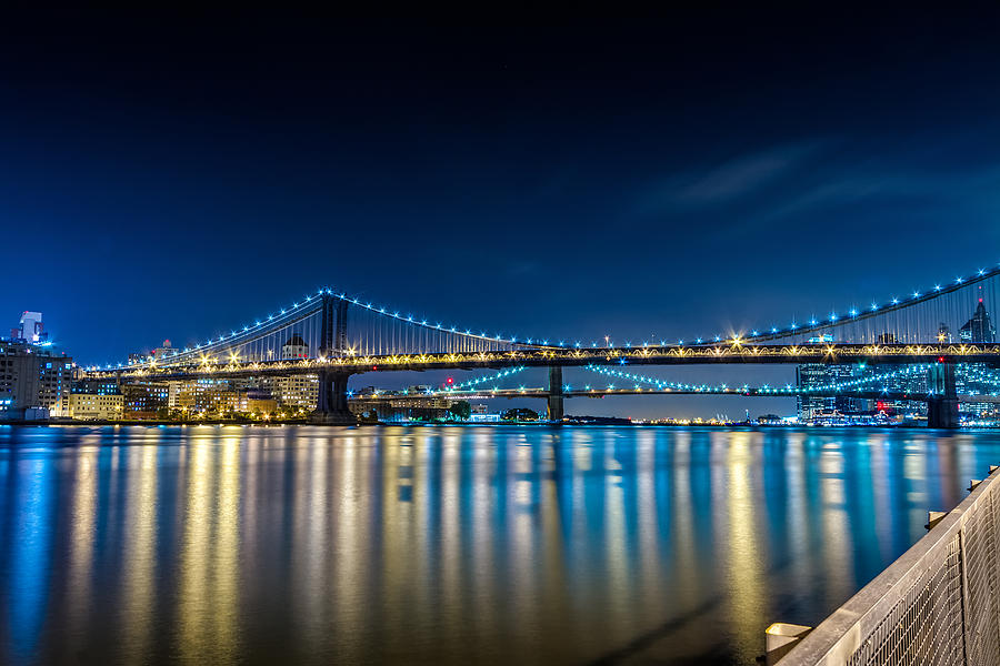 New York City Photograph - Manhattan Bridge and light reflections in East River. by Val Black Russian Tourchin