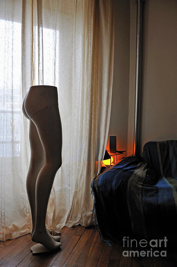 Mannequin legs by sofa in living room Photograph by Sami Sarkis