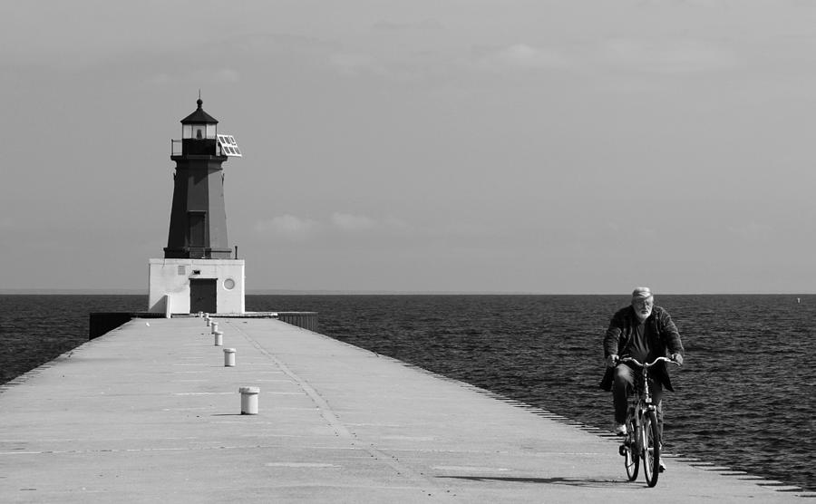 Meominee Lighthouse Biker in Black and White Photograph by Mark J Seefeldt