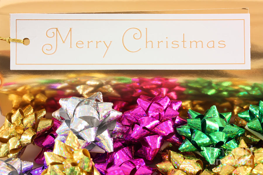 Merry Christmas message with colourful bows Photograph by Simon Bratt