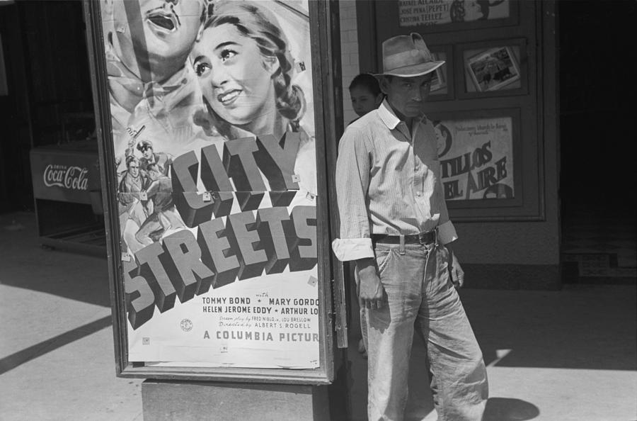 Black And White Photograph - Mexican Man In Front Of A Movie Theater by Everett