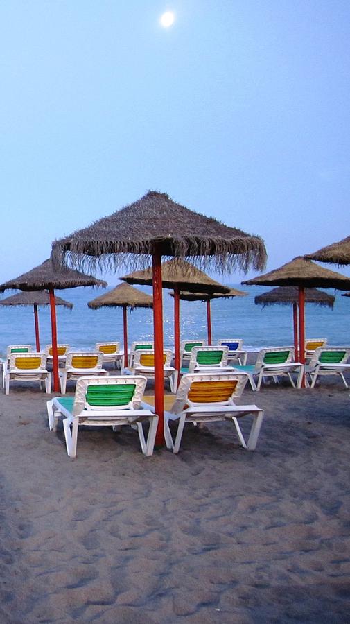 Moon Light Beach Umbrellas and Chairs Costa Del Sol Spain Photograph by John Shiron