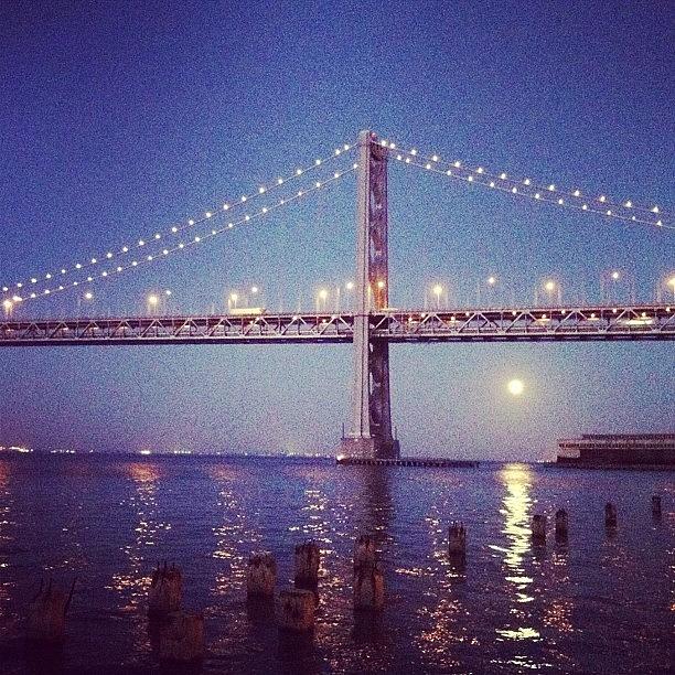 Moonrise Behind The Bay Bridge Photograph by Christopher Chan