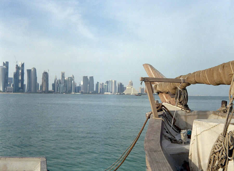 Moored dhow and Doha Photograph by Paul Cowan