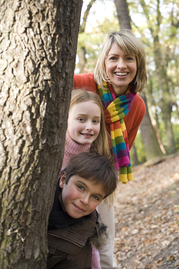 Fall Photograph - Mother And Children Playing In A Wood by Ian Boddy