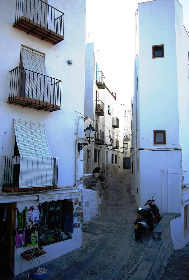 Narrow Stone Paved Street Leads to Peniscola Castle High Above in Spain Photograph by John Shiron