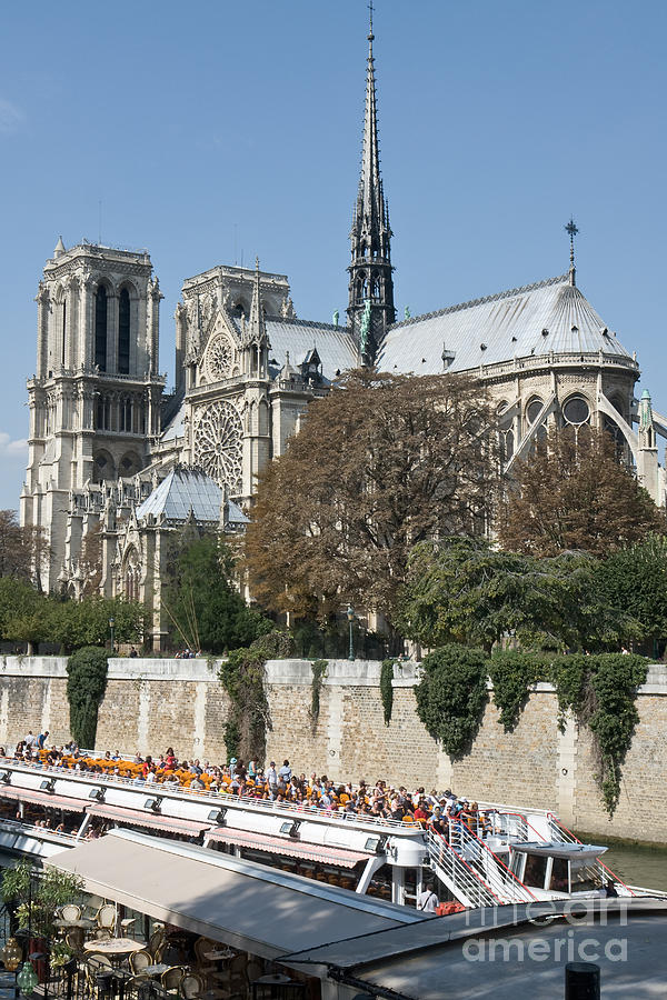 Notre Dame de Paris and river excursion boat Photograph by Fabrizio Ruggeri