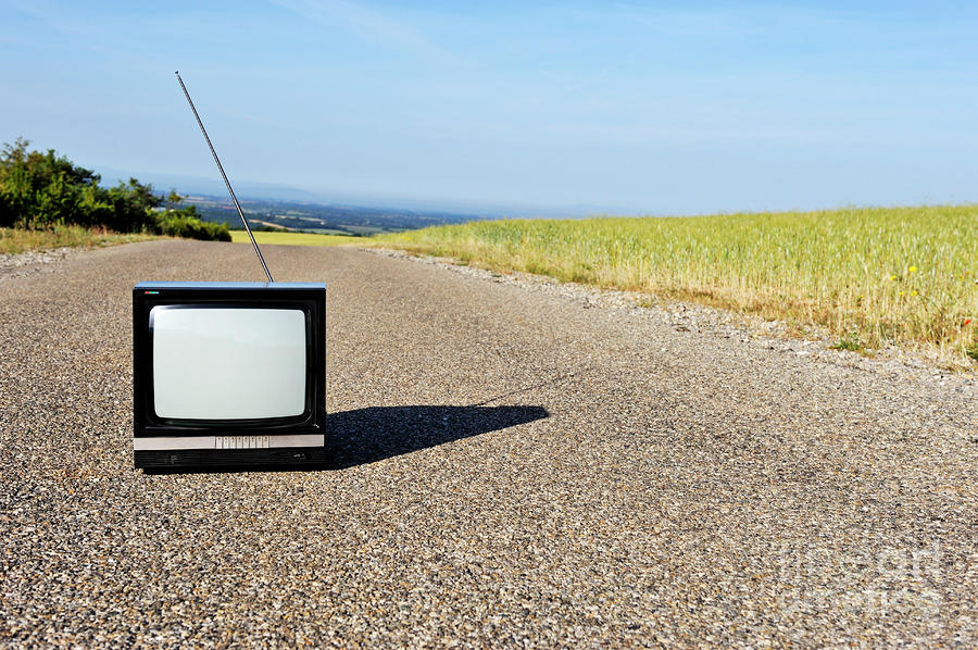 Old fashioned TV on empty countryside road Photograph by Sami Sarkis