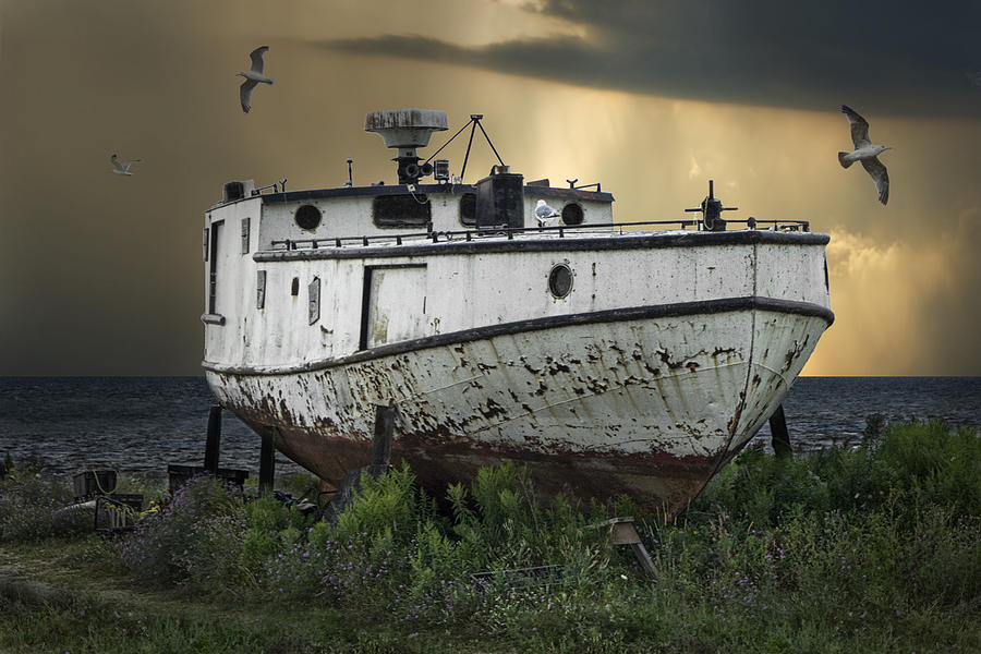 Old Fishing Boat on shore with Storm moving in Photograph by