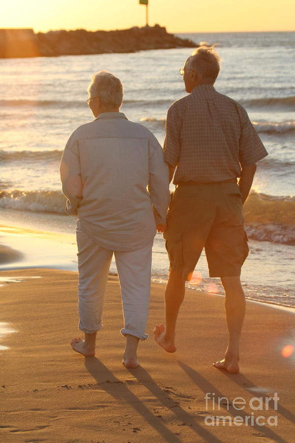 Older Couple Holding Hands Walking On Beach Photograph By Christopher